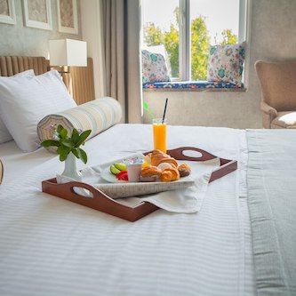 croissant boiled egg orange juice yogurt breakfast tray bed hotel room 176474 2601