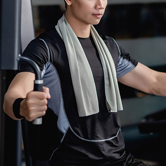 side view close up portrait young handsome man sportswear sitting doing machine chest press