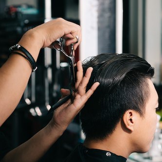 unrecognizable hairdresser cutting asian male customer s hair with scissors salon 1098 20649