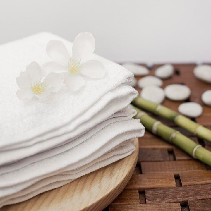 white flowers stacked towels wooden tray 23 2147927218 e1702301532443